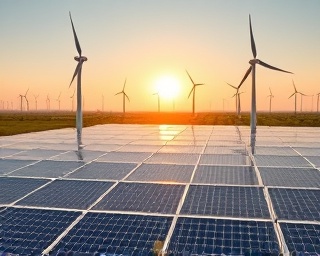 breakthrough AI innovation, focused expression, optimizing green energy solutions, photorealistic, in a solar farm with wind turbines, highly detailed, AI-controlled panels shifting, immense clarity, earthy greens and sunny yellows, natural daylight lighting, shot with a drone camera.