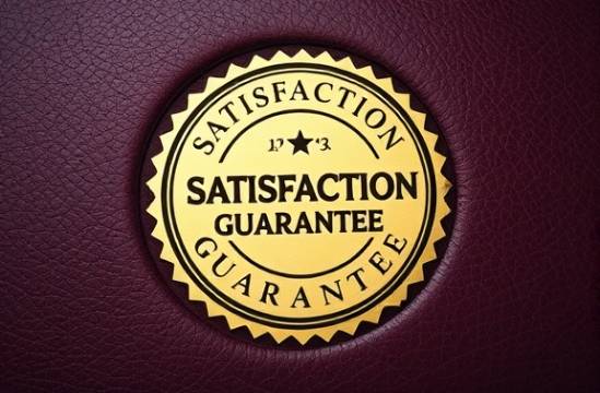 elegant Satisfaction Guarantee seal, prestigious, prominently displayed, photorealistic, superimposed on a luxury leather surface, highly detailed, texture rich, gold foil, deep burgundy, soft backlight, shot with a tilt-shift lens.